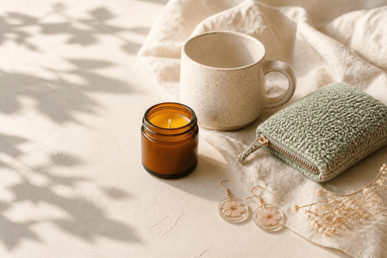A softly styled collection of handmade crafts arranged on linen